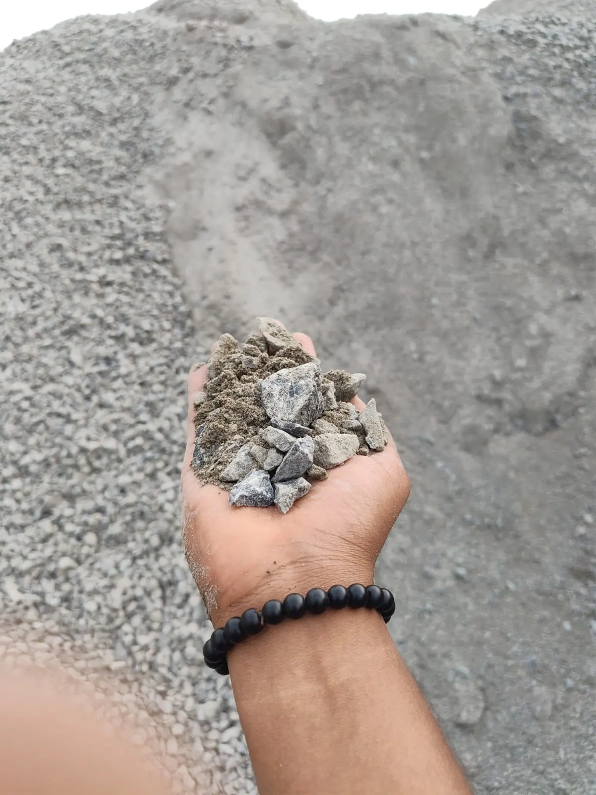 WMM (Wet Mix Macadam) — A graded mix of crusher dust, 12mm and 20mm aggregate in a controlled ratio. Base layer under bitumen roads, driveways, parking lots and compound roads.